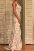 This dress exceeded my expectations. Well worth the $100. The adjustable straps are not very attractive but with your hair down and a veil it will hide it well. It is the perfect length with 4" heels. The liner underneath was longer than the lace later so I had to take it to the tailor but other than that, it is perfect for my backyard wedding. - Kara G.
