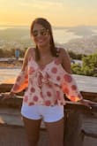 Great top, nice blouse-y material and the open shoulders make it super cute. It is a little restrictive when you raise your arms but otherwise I have no complaints. The colors are great and the little bow in the front is a nice touch. - Stephanie K.