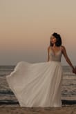This dress was everything I had hoped it would be. The beads are beautiful and the skirt is flowy. It fits well, but I might have been able to wear a size 4 since my breasts aren't very big. I love the back, the detail under the arm with the opening and how the beads fall on the top of the skirt. This dress made my engagement pictures look even more amazing and I couldn't be more grateful I chose it. I'm having another wedding ceremony in Brazil, where I'm from, and I'm definitely going to wear this beautiful flowy dress. Can't wait! :))  Photos: sb_photographs - Liciane A.