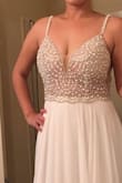 Love this dress! Especially the low back line. It was exactly what I was looking for in a wedding dress. Elegant on top, but flowy on the bottom. It's too long for me, but that was expected. - Ha T.