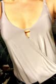 Felt very soft, but I had a hard time dealing with seeing my bra straps with the outfit. I usually like going bra-less but didn't feel confident doing so in this shirt. I also wasn't a fan of how the shirt laid in the front. Felt like I needed to pin it back. In my review pic I tucked the back of the top into my bottoms to tighten it up. Beautiful color tho, just wasn't the top for me. - Paige F.