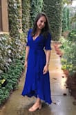 I wore this to a Fall wedding at a winery. The color is a prettier royal blue than the picture on the website. It was not tight in the arms or shoulders like the other reviews mentioned. At least not in the Blue version. The ruffle added much more elegant detail and the high low effect made it the perfect length. It was not see through. - Amber M.