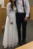 This dress was the dress I wanted from day one. I looked all around with my mother and tried on many dresses and I knew I had to take a chance and order it. My husband and I had a sweet and simple courthouse wedding and it was perfect. He told me right when he saw me it made him emotional. I am very petite so I had the arms shortened the bottom shortened and the sides of my ribs tucked in but this is beautifully made and I absolutely adored it. Thank you lulus! - Grace G.