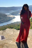 I bought this dress for my engagement shoot because I was looking for a flowy dress. Pros: -very flowy and soft (I could've been in it all day!) -color really popped in the pics -fit like a glove -loved the lightweight material -exactly what I was expecting. 

Cons: -The dress has no stretch so be mindful of that. I ordered a M, which is my usual dress size, and it fit perfectly. - I have a very short torso so the look in the back wasn't the same, which was a little disappointing but that is a personal thing. If you have a long torso you will be fine! - One thing I wasn't too excited about was the underlining. In my pics, you can see the difference between the full length and the underlining (again another personal thing not a deal breaker!). 

Overall I am happy with the dress! Versatile in that you can dress it up or dress it down! I'd say its a winner! - Anusha S.