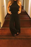 So I bought this jumpsuit for a wedding and fell in love with how it made me look and feel. I'm not very tall, so the high waist and long wide leg made me feel tall. However, I had to get this jumpsuit tailored in the waist because it was way too loose and then I had to get the legs shortened, even with my highest heels. Instead of shortening the legs at the bottom of the pants, my tailor cut the waist in the front and lifted the pant section up to shorten the legs and so that the intimate area doesn't hang super low (because as other reviewers said it really does). Now, the jumpsuit fits perfectly and I love it.... but I paid MORE for alterations than I did for the actual jumpsuit. - Lucy K.