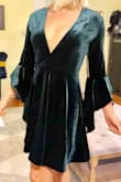 Once I took it out of the box I could tell it was good quality.  Nice thick fabric that will keep you warm. Soft and cozy. The dress is given a sexy look by having a very low cut v neck. I might get it tailored because of some extra room in the bust but I wouldn't size down.  
I have an athletic built with broad shoulders - this dress was still super comfortable with room. So if you are more petite, I suggest sizing down.
Was planning on wearing this to a work party but I might feel a little uncomfortable with the low V cut unless I pair with a scarf. - Paige F.