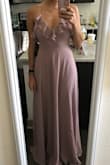 This dress is so flattering and pretty on! It has the perfect amount of flow, and the straps are adjustable for my shorter torso. It fits perfectly, so I'll be wearing it for a March wedding! The color looks more purpley in some light and more pink in darker light. It's a very light mauve. - Katherine P.