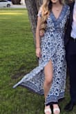 I got so many compliments on this dress. I wore it to a wedding and I wore heels with this dress as well so it is definitely long enough for tall girls. Only thing was the slit/ the wrap part easily came open. I used fashion tape to keep it closed which worked for the most part. - Maddie