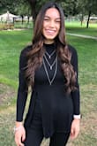 I was in need of a plain black top and I am so happy I bought this! It has been a staple piece in my closet. I love dressing it up and keeping it a little more casual for work and going out. The slit is a little higher than I would have liked which is the only reason I have it in a 4. I have to wear a tank top underneath to cover skin. - Amber A.