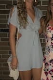 This dress was cute, the fabric is almost like a linen material, the only downfall is there is absolutely no stretch at all. I ordered a S and it does have a zip up the side so thankfully it fit me. This may have looked better with more cleavage, the V-neck is much lower than it appears on the model. I was going to a ceremony, so I had to stitch it above the knot which unfortunately kind of ruins the "tied in a knot" look. All in all it was a decent purchase - Delaney S.