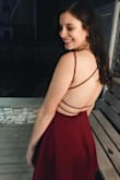 I absolutely love this dress and the back details. The material is clearly good quality, and thick enough that you don't need to wear a bra. The waist/chest area was a little loose on me, but not so much that I felt I needed a smaller size. I wore it to a sorority formal and felt comfortable in it the whole night. - Jessie S.