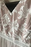 As soon as I pulled this dress out of the shipping dress, I was in awe. It's so girly and dainty. I was immediately in love with it. I ordered a medium, however, which was way too small for my measurements. If I wanted to keep the dress, I would've exchanged for a large.
I returned this item because it just didn't feel like a wedding dress. I think I would've considered it if it were pure white or even ivory, but this dress comes off as pink to me. Still, it's a pretty dress for a bridesmaid or some other occasion. Make sure to wear a slip under it thought; it's pretty see-through. - Julianna R.