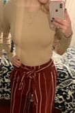 I love this top! It is very slimming, and the material is thick. It is a little cropped, but it goes perfectly with high waisted pants. I 100% would recommend to anyone looking for a cute, versatile sweater! - Emelie N.