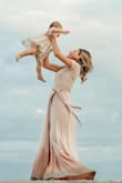 I wore this dress for a family photo shoot on the beach. While the material was heavier than I expected, I loved how it was a true wrap dress so I could secure it perfectly to fit my body. It was very comfortable and it's a great subtle blush color. The photos turned out beautiful and I've received many compliments on the dress! - Amanda C.