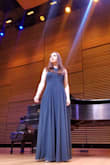 This dress is a statement maker! In a sea of black recital dresses, I really stood out in forest green. The color is very close to the product image provided (my photo was taken under multi-color spotlights, which is why it looks darker). The fabric is not too heavy, though the hem does tend to drag on the floor unless worn with high heels. Will be purchasing this in other colors! - Angelina B.