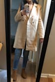 I got a size small and it was too big. It looked like I gained 20 extra pounds. In the picture it looks like a slim fit but in real life it was so boxy and unflattering. I saw other reviews that said the same thing but got it anyways and now wish I listened to them. Besides all this, it's a lighter camel color than shown and the material looks extremely cheap in person. You know when you buy clothes on eBay that look super cute in the picture but in real life it's just a cheap knock off? That's this coat. Definitely returning it. - Raquel F.