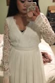 I am in search for a wedding reception dress and thought this would have been perfect. The dress was really pretty and looks just like the picture. It is a little heavier than I was expecting. I returned it because my torso did not seem long enough for the dress, so it fit a little awkwardly on me. I believe the sizing is pretty true. I'm in between sizes (Small/Medium), the Medium was too big for me, the Small was more my size, just an awkward fit for my short torso. I'm also pretty short, so the dress was very long. I wish I could wear this dress! I love the back detailing! - Gieselle S.