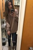 I wear this sweater all the time and everyone asks me where I got it. The back is low and looks super cute, it falls just onto my shoulder (pic included), and it's a baggy fit which I love. The color matches just about everything I own as it's super neutral. I would highly recommend!!! - Jessica P.