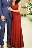 The color is a true red, not burgundy or deep red. The front touched the ground in 3 inch heels and the back had a short train. The wiring that keeps the front from collapsing is stiff. The back dips to about the waistline so a low back or backless bra is necessary if one is to be worn. - Michelle O.