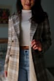 This is by far my favorite coat from Lulus because of it's perfect fit. I'm a petite gal and most coats are too long on the arm, but this one's totally not the case. As the photo shows, it looks great with jeans and a light top. I wore it for the first time today and already received compliments. I do agree with some of the reviews; you're going to want to wear a second layer of cardigan/sweater if you're going out into the cold because it is pretty thin. But don't worry, it does not look or feel cheap at all. - Maricris B.