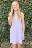 This dress is so pretty and cute! I love the vibrant lavender color and the detailing on the sleeves. It's so cute from behind if you tie the strings in a bow. - Taylor H.