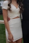 I am petite but it fit perfectly! I was pleasantly surprised! The skirt was a little too long so I got about 2-3 inches hemmed off. I got lots of compliments on this dress! But.... I was disappointed with how much the material pilled (last picture). I love this outfit but I am bummed I won't wear it again due to the pilling. - Mia C.