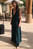 I wore this as Matron of Honor in my sister's desert wedding. I didn't make any alterations. Just needed a good steaming. 
Everyone was complaining about the dress being too long, so I knew I needed to order it. It almost touched the ground barefoot. With heels on it was the perfect length. 
I have a very flat chest so I just Velcro'd some shoulder pads into the chest parts to fill it out a little and it stayed all night. 
The sleeves don't slip, but you do need to stand up straight or you might give a little side boob. 
The slit is pretty high, so I wore some short black undershorts that I wear to the gym. I didn't want to surprise anyone if a gust of wind came and blew open the dress. - Tiffany L.
