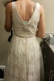 I love the dress style overall and can't beat the price! Not a fan of the tulle overlay; but the neckline, back, belt, and lace are beautiful. I'm planning to use this as my wedding dress after some alterations. The dress is very snug around the waist, but matches the size chart accurately. - Lynn M.