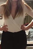 I recommend to size up. I wear a medium normally, but tried the large and it fit well, except was a bit short in torso (and I don't have a long torso).
But oh, how flattering this top is! But man it's tricky- I wore it with mid-rise jeans and the bottom pops out a bit. Also, the top sits well one minute and then opens up revealing my bra the next. So using a pin is necessary for me. - Marianna H.