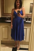 Love this dress! It is all about how well you tie it as that is how it stays on. It is a gorgeous color and so fun to dance in. I wore it to my cousin's wedding in early September. (No bra and everything stays in place!) - Jennifer Z.