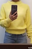 I've been looking for a nice lemon yellow sweater and I found this one. The knit is wonderful - great material, seems nicely made. The problem is when I tried it on it seemed to fit so strangely. The arms are really long and the neck seemed so huge! I ordered an XS and I normally wear fitted clothing, not slouchy, loose clothing. Because I've been wanting a sweater this color and that is hard to find, I thought I'd try to get it tailored... apparently sweaters can be tailored. But then a couple days later I decided to try it back on. I think it's OK. I pulled the sweater down so the neck wasn't so high and then it didn't look so bad and the sleeves apparently are supposed to be long so that you can bunch them up. I played with them a bit and now I think it doesn't need to be tailored, I just have to really style it well. Also, with it fitting so loosely, it doesn't provide much warmth. - Jennifer W.