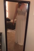 I ordered this dress in a size 8 for my courthouse wedding after reading all the positive reviews. The dress arrived very quickly and it fits me almost perfectly with heels on (I'm not wearing heels in the picture). The waist was just a bit loose and the straps are a bit tight on my shoulders. The beading on this dress is gorgeous and high quality. I love that this dress has a bit of a train on the back as well. I'm looking forward to wearing this dress for my wedding. - Kezia W.