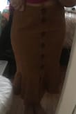 I am going to return this, which is a huge bummer considering I was so excited for this skirt. First, it runs big. I ordered a medium (due to my hips), and I def had some extra room. I have curves, and it didn't hug them at all like the model. Also, I'm short, but it was a bit longer than I thought it would be. Overall, it just looks ill-fitted and wonky. I could try for a small, but I feel like it may not be worth it. The color isn't as vibrant as the photo, but still a decent yellowish brown. The material is also thin, fairly cheaply feeling. - Brooke H.