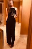 Love this jumpsuit. The back adds just a bit of sexy, and it cuts just at the right point. I had to get it hemmed about 1.5 inches since I wanted the small to fit around my butt. I'm an XS for height, XS on the top, and an S in the rear. - Cec R.