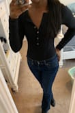 I love this bodysuit! The fit is great and definitely true to size for me but because of my long arms, I wish the sleeves were just a tad bit longer. I like to have my long sleeves go past my wrists not sit 1-2 inches above. I have to pull them down... but I can't complain too much because I do have long arms lol! - Tamera F.