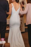 I wore this as my wedding dress for a small wedding with less that 30 people in attendance. I only altered the shoulder straps so the dress did not dip as low on my chest. The length was maybe a hair long but I did not feel it needed altered. I wore flats. It is a simple dress but when I added some jewelry and flowers, I thought it looked beautiful. I am so happy to have found this dress at this price point - the last thing we wanted was to start our marriage stressed about wedding debt. - Tj G.