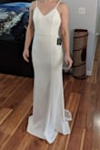 I ordered the small because I fit another Lulu's dress in small but because the material was stretchy this dress was so loose. The lace is very delicate in the train and it has a floral motif. The front is completely plain. It wasn't for me but I loved the back with the buttons. - Danielle D.