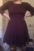 This dress has a nice thick, stretchy material, but was a little darker in color than expected. I ordered a size up after reading everyone else's reviews and I'm really glad I did. It is the perfect length and can be dressed up and down with different accessories. If you have a larger bottom half I wouldn't worry about sizing up, but if you have a larger chest I definitely suggest it! - Kierstan M.
