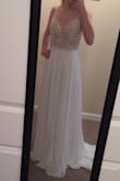 I would have ordered a 0 if it had been an option. I'm going to see if I can have the straps and waist taken in without completely destroying the beading, if not I'll return. Wish they'd offer in a 0 to begin with. But overall it's pretty nice quality and fun. I plan to wear it as a reception dress. And yes obviously unless you're 6 feet tall, it'll need to be hemmed. And the skirt is a little sheer, so wear nude undies. - Kelsey M.