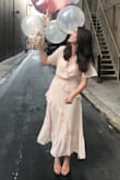 I wore this dress to my bridal shower and I am obsessed!! I got so many compliments  and loved the way it looked. I did have the waist taken in quite a bit - I am 5'6 so I am usually a medium, and the sleeves sewn together but these small changes made the dress absolutely perfect! Will most definitely be wearing it again! - Emily G.