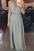 Loved everything about this dress and received lots of compliments. Tight enough in the waist band to feel secure up top but nice and flowy on the bottom. The slit is just the right amount of sexy. The material is light and slightly see through, so I recommend wearing a nude color spanxs/bottoms. I crisscrossed the dress in the front and twisted the straps down the middle of my back. I am smaller chested and it felt more comfortable this way. The straps are long enough that you can tie the dress multiple ways. This is a must have! - Ashley R.