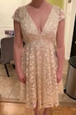 Love this dress! It's a perfect mix of conservative class and sexy skin. The material is nice and heavy, the length hits just below the knee and the skirt is fun and flowy. The kind that twirls when you spin. I was worried about the  the top clasp in the back behind the shoulders as I have very broad shoulders. I was worried it would either be too tight across my back or break when I slouched my shoulders forward. It is neither too tight or break-able. The clasp is actually a thick elastic that goes around a very secure button so if you have to bend over it stretches WITH YOU. I bought this dress for my rehearsal dinner party and I can't wait to wear it all done up! - Amanda H.