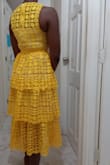 This dress caught my attention online because of the gorgeous bright yellow and the eyelet lace, which is always a favourite fabric of mine. 
It did not disappoint. 
I typically wear XS at Lulus and that's the size I ordered. But beware the waist has NO give. So my 32DD bust and 25/26 inch waist just barely allow the zip to close in the rib cage region...the rest zips easily. Perhaps a size small would be more convenient.  But that's no fault of the dress and I'll be keeping it since its not dreadfully bothersome to me.
Quality is great and the lining is modest. Sure to be a favourite for a few years to come. - Barbara H.