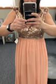 Beautiful dress and great quality. I would not have chosen this dress for myself, but I am in a wedding and the bride chose this dress for me. I am paying more for the alterations than the dress! The associate told me to order a medium based on my bust size, and the dress was huge everywhere except my ribcage. I couldn't even zip it. I asked the seamstress if I should order a bigger size and she said no because it is already too big, it is just my ribcage preventing it from zippering. This dress is definitely suited for a taller frame as you can see all the extra fabric in my shoulders. Overall great quality beautiful dress, just not something that works for my body type. I will post before alterations pictures now and after alterations in about a month. - Shanna S.