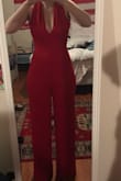 I love this jumpsuit so much that I convinced some of my friends to all order it in different colors. I'm calling it Power Rangers Meets Charlie's Angels. I ordered a medium first and it fit, but was a little too loose around the waist and rib cage. I exchanged for a small and it fits like a dream. There is stretch and for my friends that are on the short side, the crotch can be super low. I have pretty wide hips so mine worked out fine. Buy it! You'll love it. - Elizabeth D.