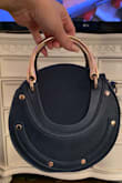 Perfect little bag to dress up an outfit. It fits quite a bit too. I've been using this as an everyday bag and the handles haven't tarnished and the bag shows no signs of wear. A must buy!! - Cynthia M.