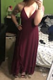 This dress is perfect for the wedding I'm in over the summer. The fabric is light and flowy. It's a little tight in the waist, and the lace up part slips down a little, but it still looks really good on! A large would have been way too big. I love the slit! - Jessica G.