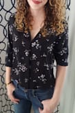This top is so gorgeous. I love the way it fits, is versitile in what I can wear it with and doesn't need to have an undershirt worn with it because it's not see through! I have received so many compliments when wearing this top and it's one of my favorite tops. The fit is true to size and both my mom and sister wanted one as well! I feel so confident in it and I can keep things very classy and business looking, or change it up and bring my sassy side out by paring it with a tight skirt. Love it! - Erika P.