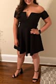 I got tons of compliments on this dress! I ordered both a large and an XL, and ended up returning the XL. The large was snug but looked better than the size up! The fabric is stretchy and very comfortable. The V in the top has a metal wire structure to hold its shape. I wore a strapless bra with it, but someone with a smaller chest could get away without one! - Sarah B.