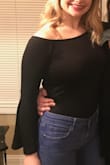 I never once adjusted this off the shoulder shirt! It stayed up and never came up or down! The material is much thinner than I thought it was going to be. Felt a little like a thin leotard type material. I kept the shirt and do really like it, just wish it was a bit thicker! - Amy L.
